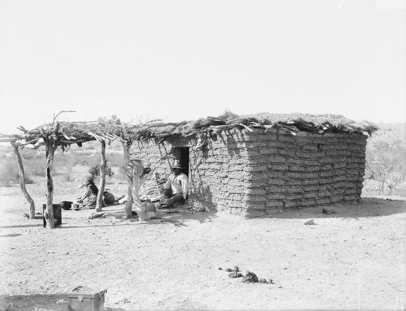 Picture shows the Adobe brick house with sunshade from 1894