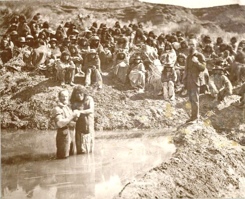 Picture shows Mormon missionaries baptizing Paiute Indians in the Virgin River, 1875. Early Mormons believed that Native Americans were descendants of a lost tribe of Israel, and therefore believed they had a special duty both to treat them fairly (Brigham Young outlawed the owning of Native American slaves) and to convert them.